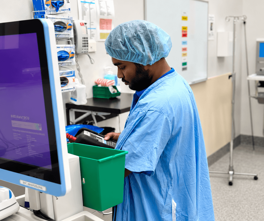 Biomedical technician testing medical equipment in a clinical setting